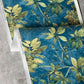A detail photo of Eskayel’s Plumeria Shadows wallpaper pattern in Tide Pool, a colorway featuring a deep blue background.