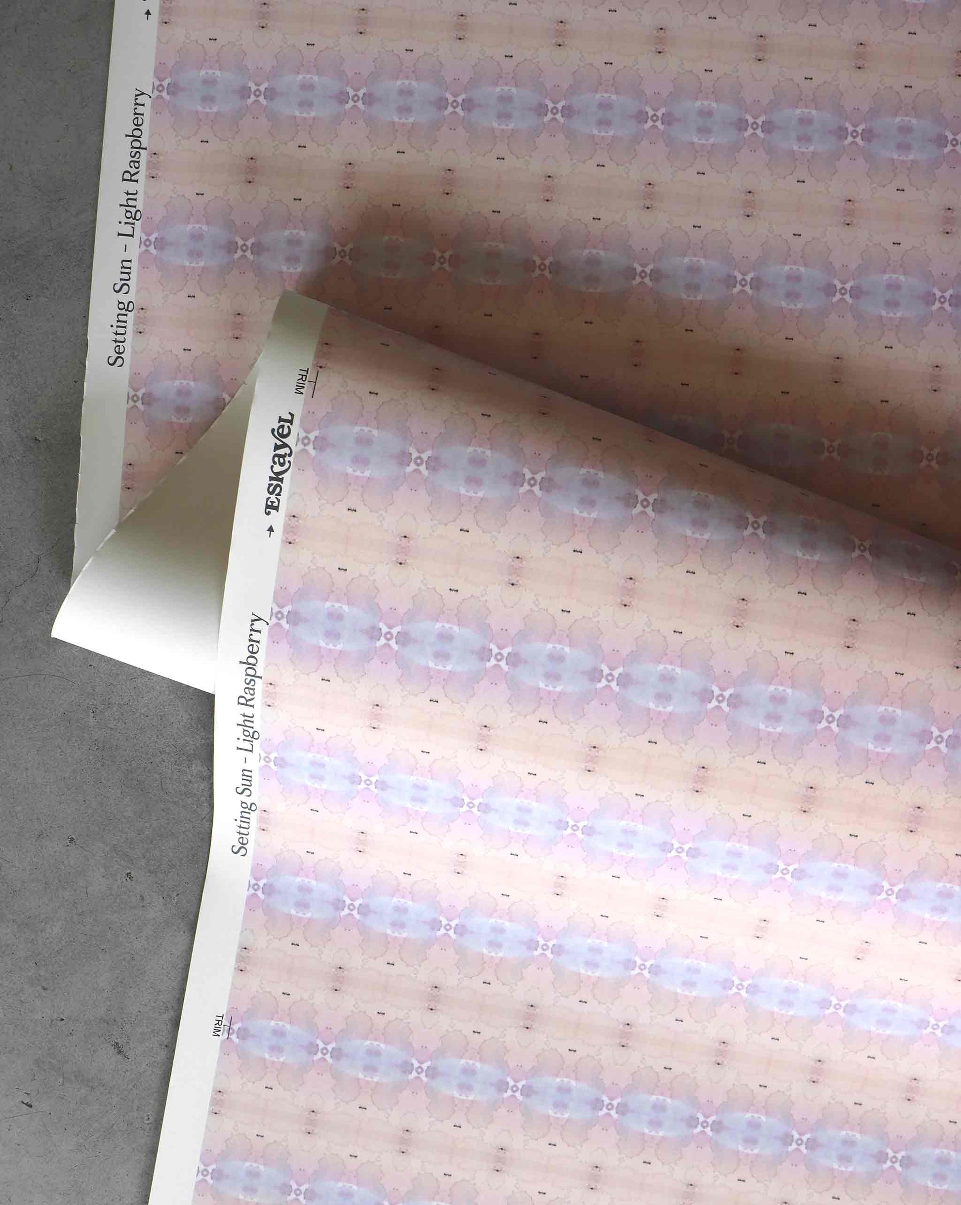 A detail shot of Setting Sun Wallpaper in the colorway Light Raspberry which features a pink and blue hue.