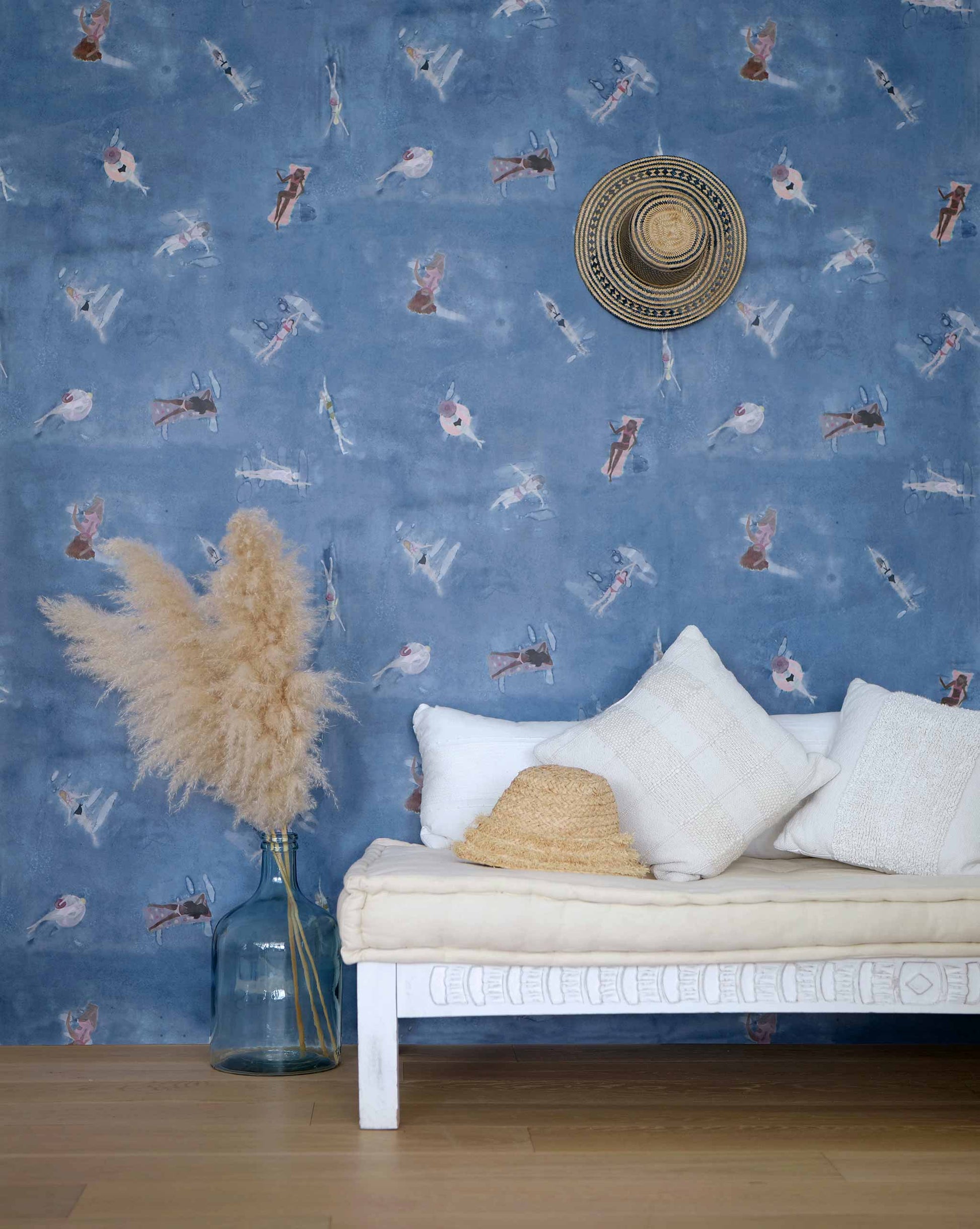 Eskayel's Swim wallpaper in the colorway Lake in navy blue with waterborne female figures installed in a room.