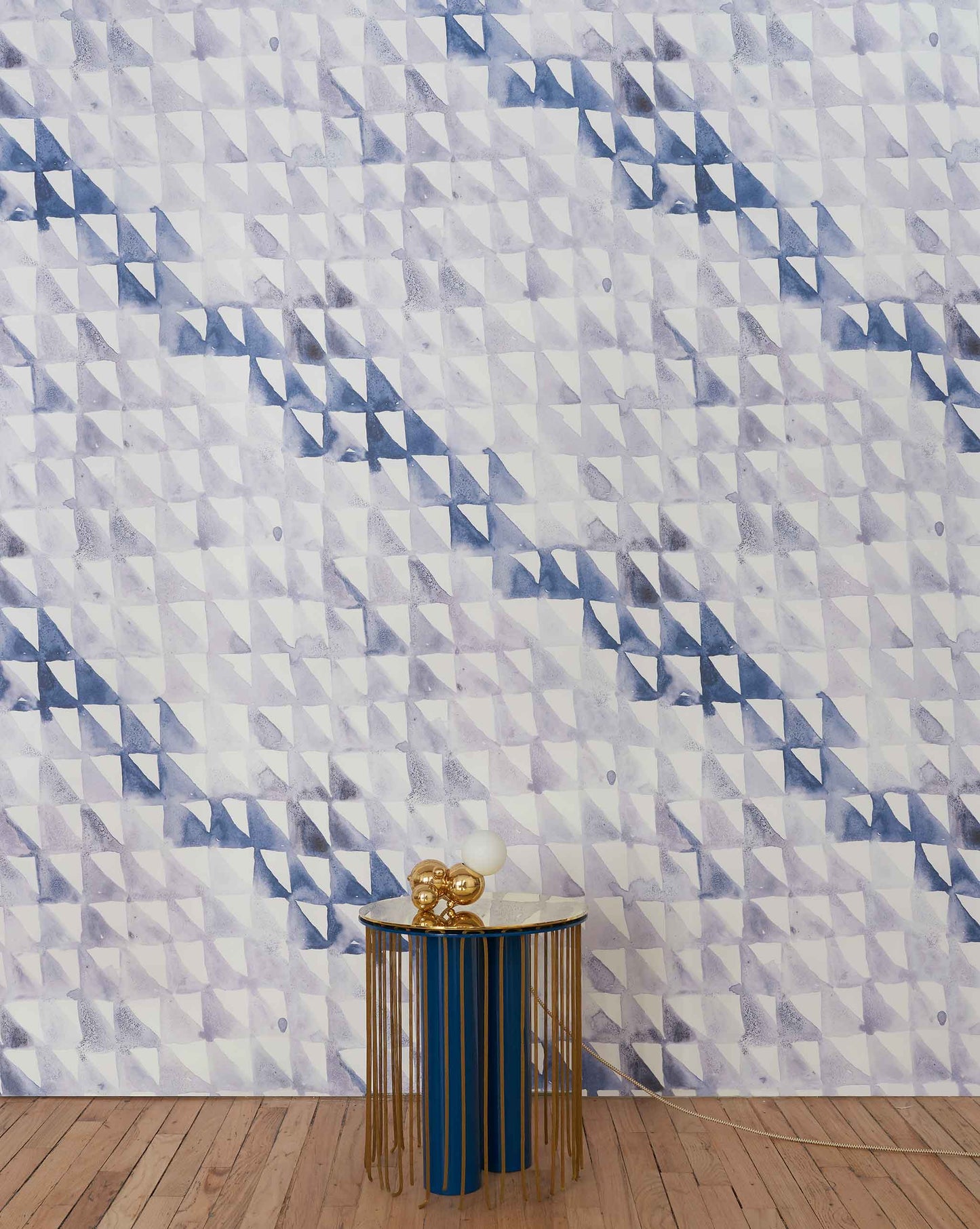 A blue and white luxury geometric wallpaper in a room featuring the Triangle Checks Wallpaper Ocean collection from a geometric sequence