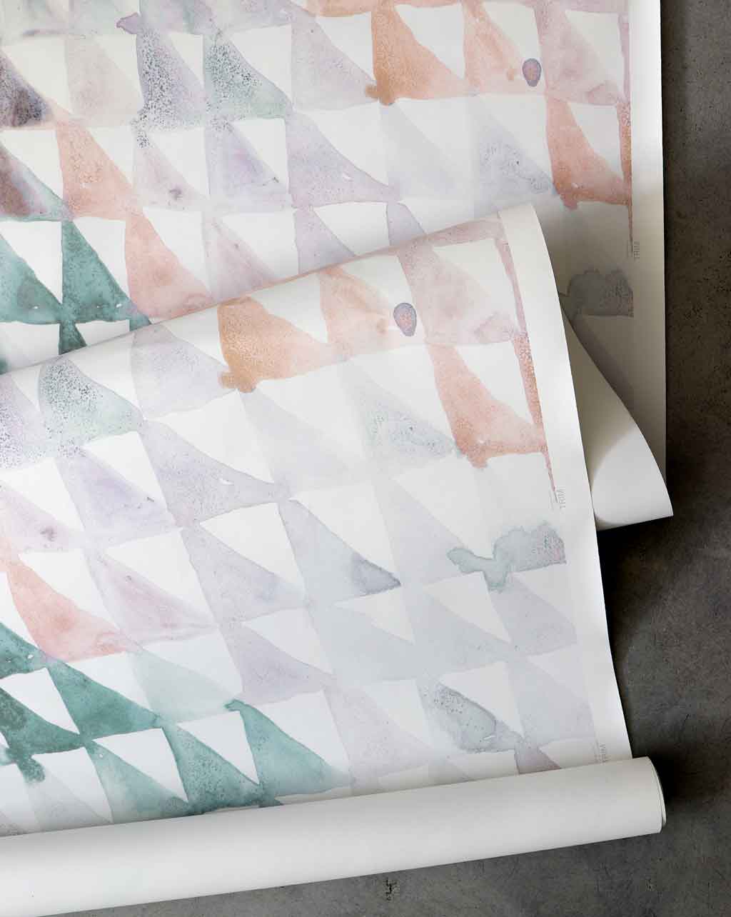 A roll of Triangle Checks Wallpaper||Reef with watercolor designs in Reef colorway.