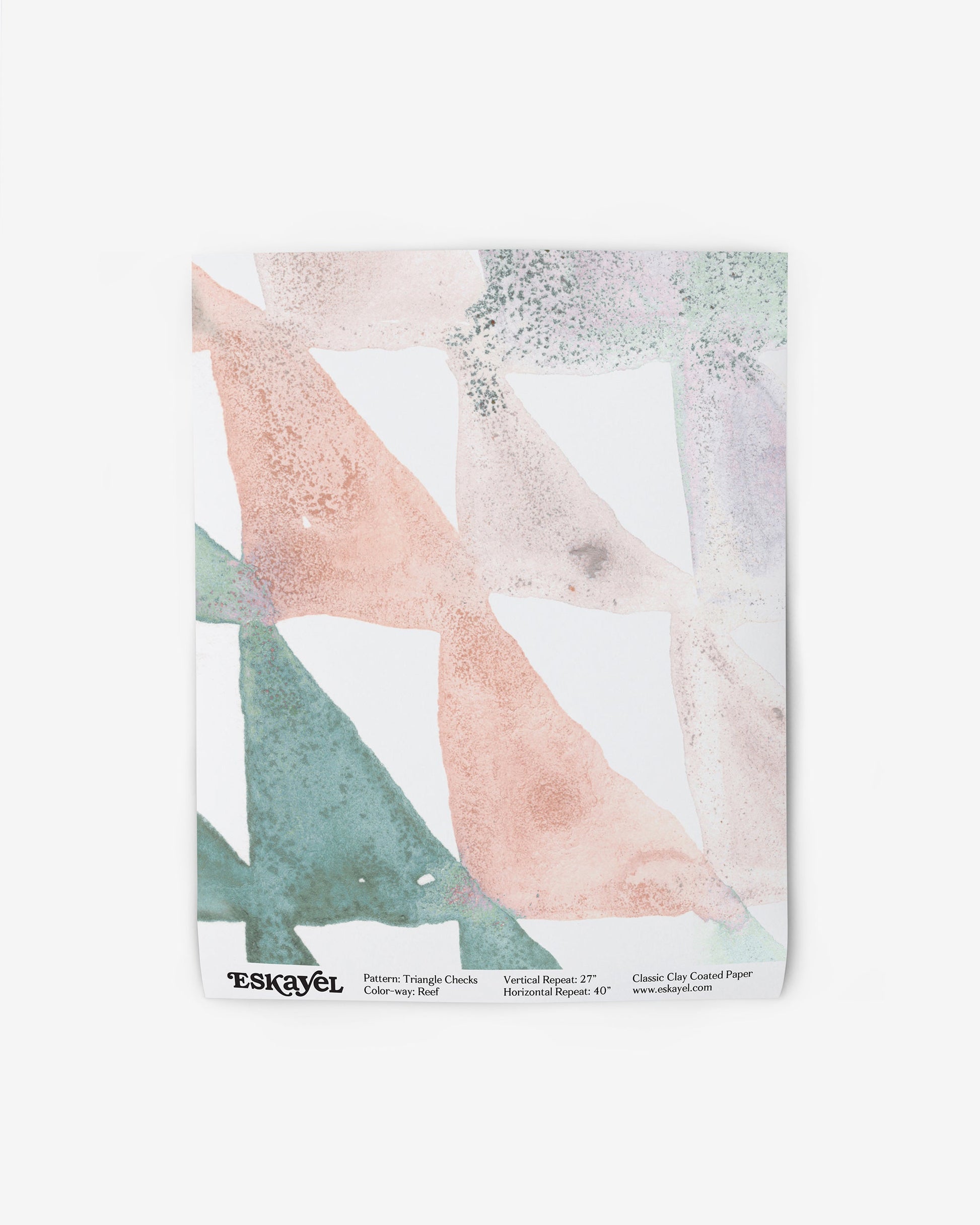 To order a sample of the Triangle Checks Wallpaper Sample||Reef with a pink, green, and blue pattern towel.