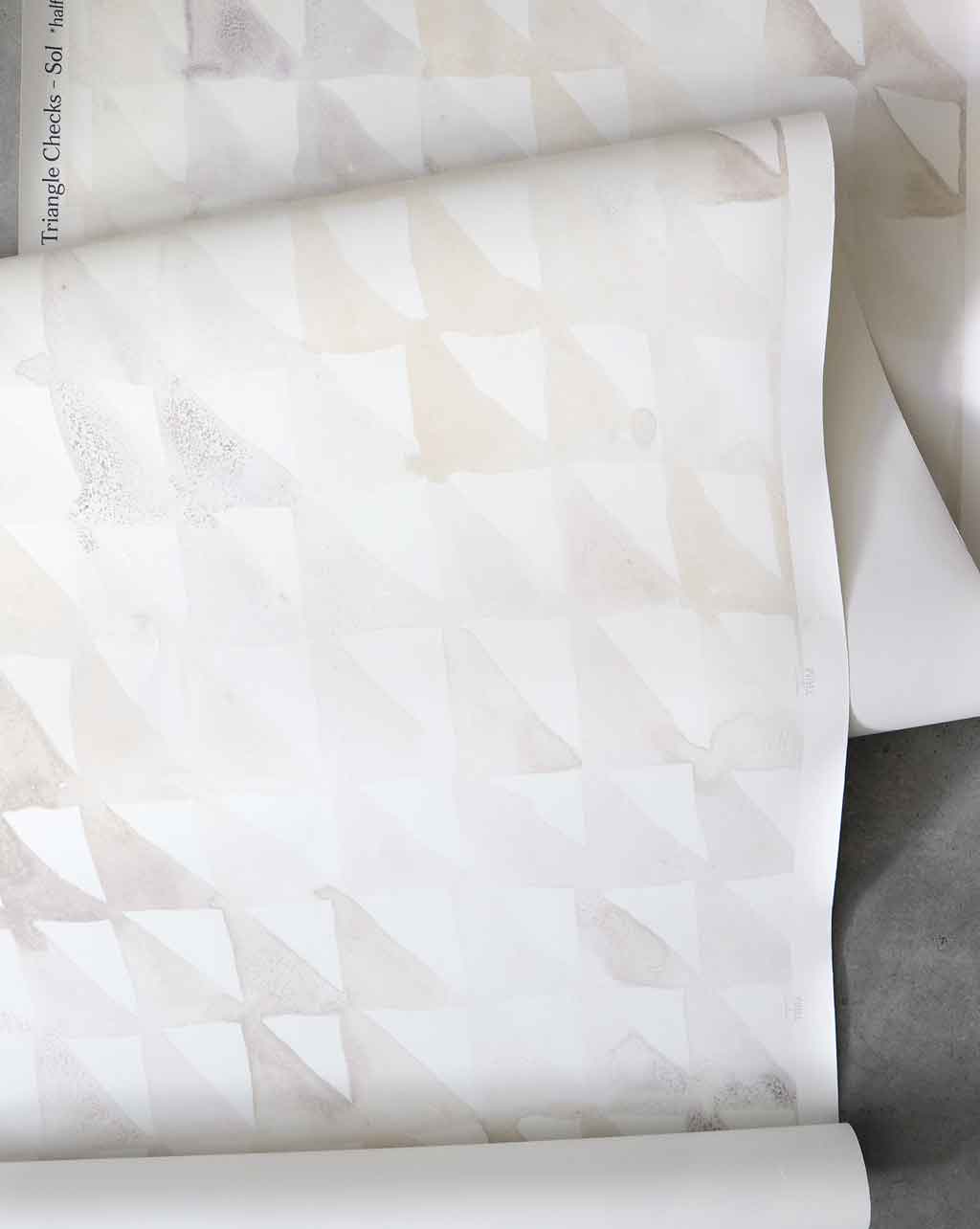 A roll of Triangle Checks Wallpaper Sol with geometric patterns on it