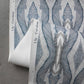 A detail shot of Eskayel's Ula Wallpaper in the colorway Cerulean with a blue, white, and grey design.