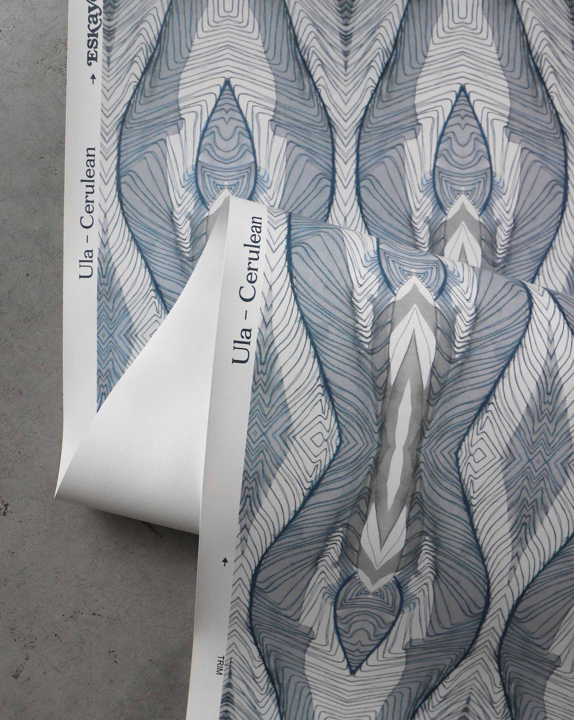 A detail shot of Eskayel's Ula Wallpaper in the colorway Cerulean with a blue, white, and grey design.