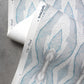 A detail shot of Eskayel's Ula Wallpaper in the colorway Pool with a teal,white, and grey design.