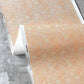 Yaya wallpaper in Grapefruit in close up — beach-themed graphic botanical wallpaper in pale peach with highlights of light yellow | Eskayel