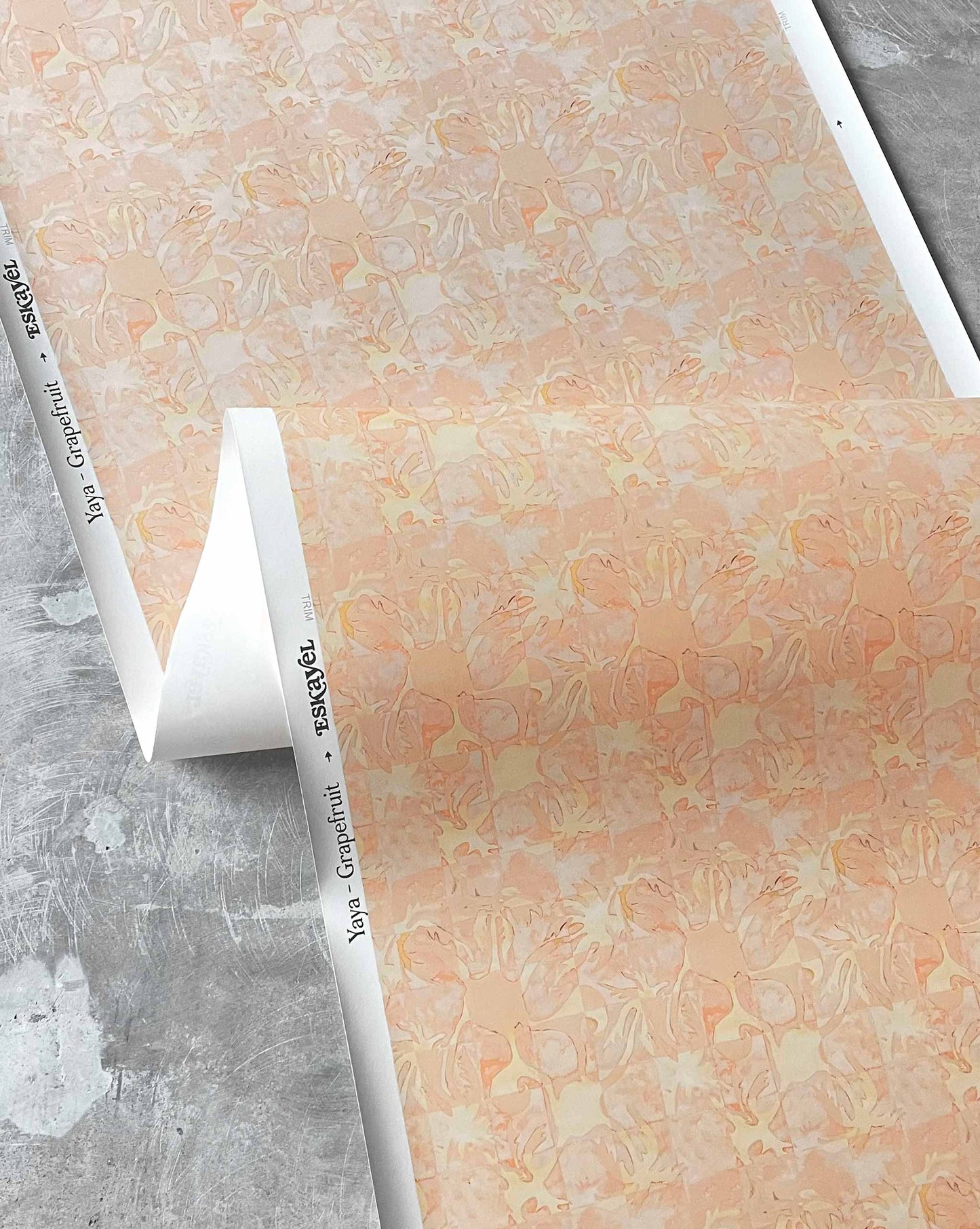 Yaya wallpaper in Grapefruit in close up — beach-themed graphic botanical wallpaper in pale peach with highlights of light yellow | Eskayel