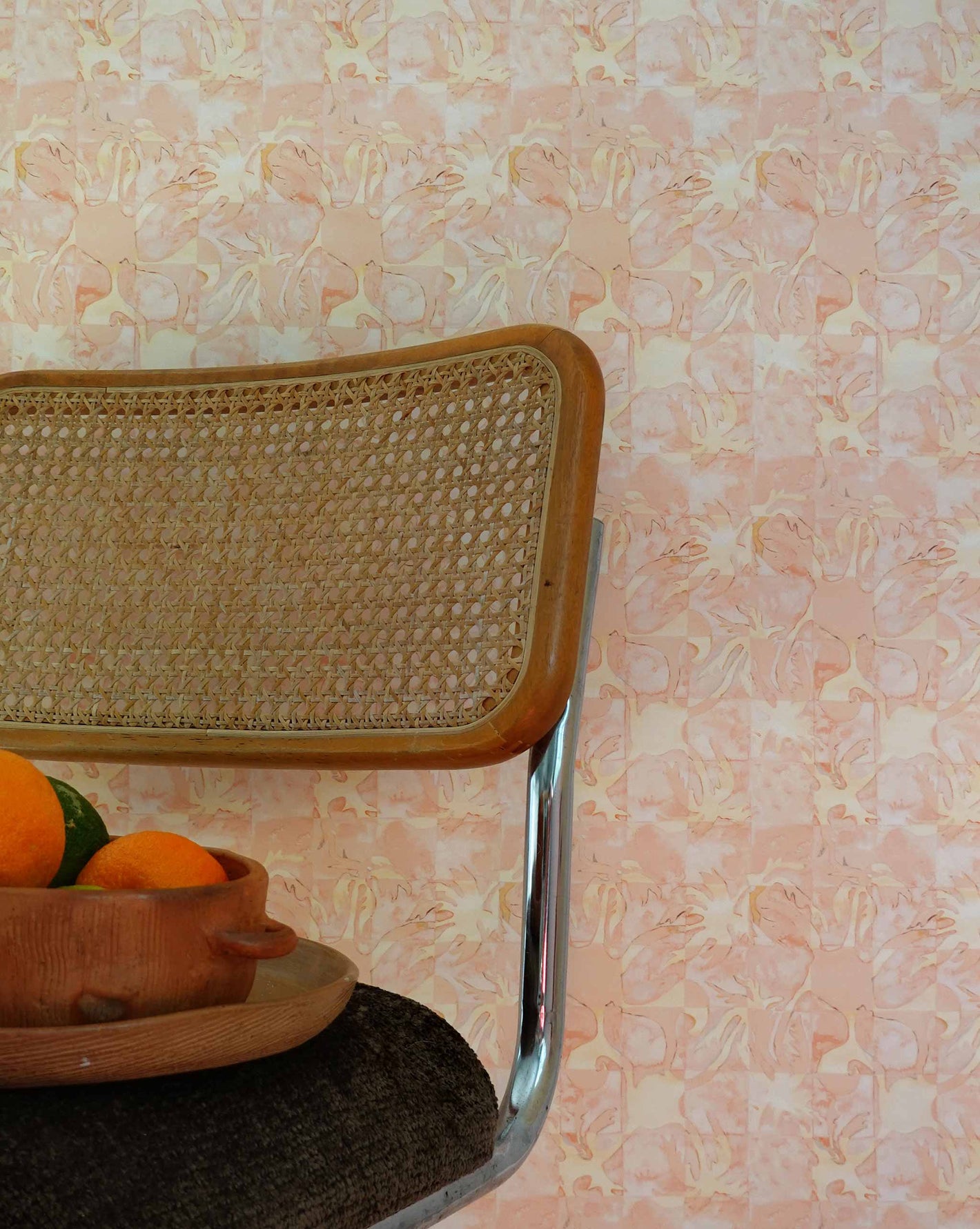 aya wallpaper in Grapefruit installed in a room — beach-themed graphic botanical wallpaper in pale peach with highlights of light yellow | Eskayel