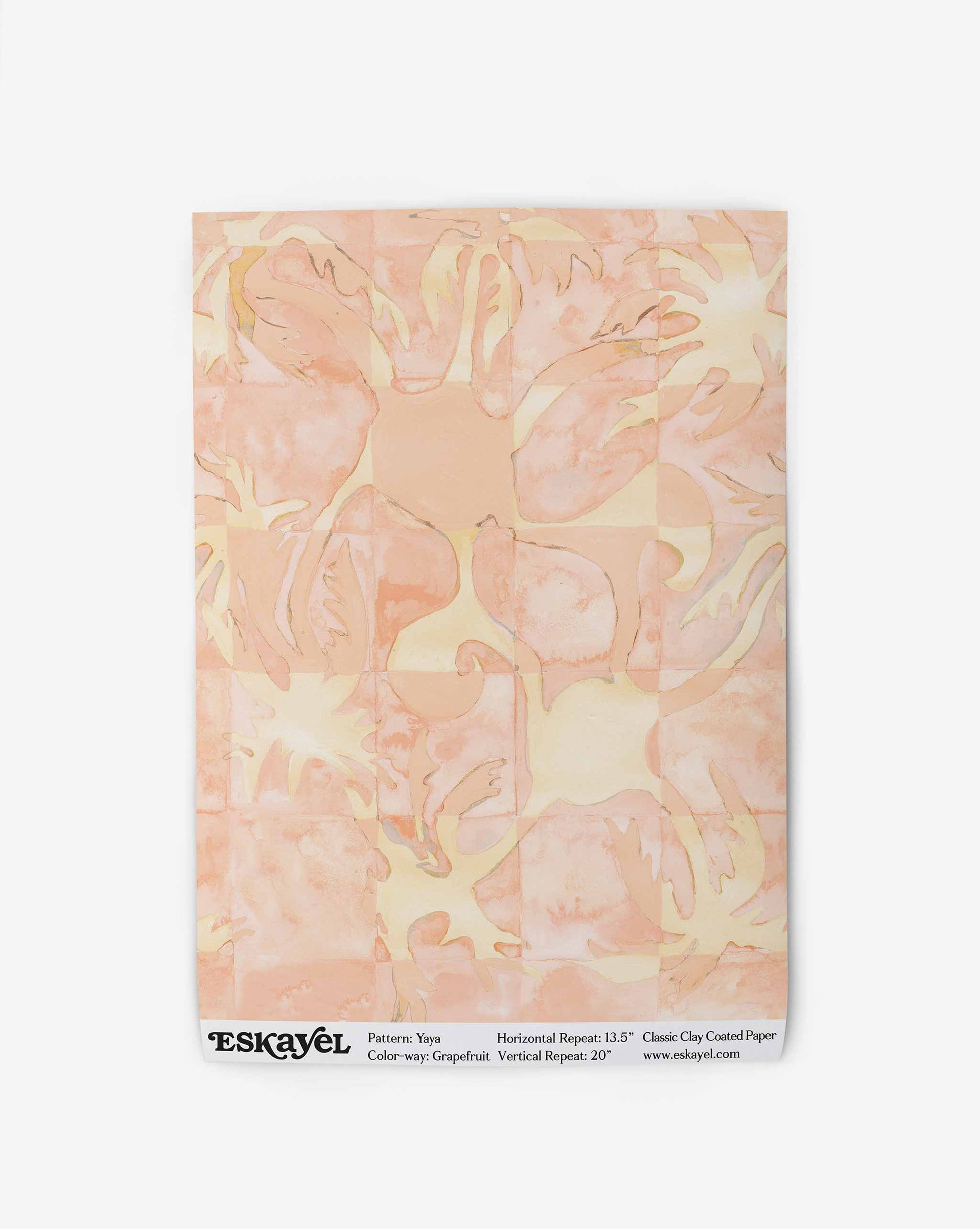 Yaya wallpaper in Grapefruit as a swatch — beach-themed graphic botanical wallpaper in pale peach with highlights of light yellow | Eskayel