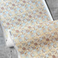 Yaya wallpaper in Husk in close up — beach-themed graphic botanical wallpaper in creamy yellow, earthy brown, and light blue | Eskayel