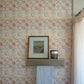Yaya wallpaper in Husk installed in a room — beach-themed graphic botanical wallpaper in creamy yellow, earthy brown, and light blue | Eskayel