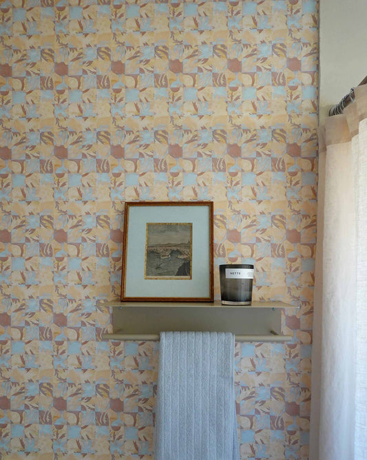 Yaya wallpaper in Husk installed in a room — beach-themed graphic botanical wallpaper in creamy yellow, earthy brown, and light blue | Eskayel