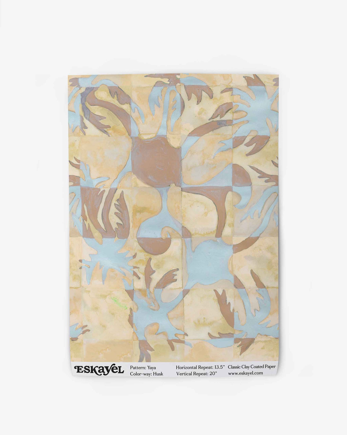 Yaya wallpaper in Husk as a swatch — beach-themed graphic botanical wallpaper in creamy yellow, earthy brown, and light blue | Eskayel