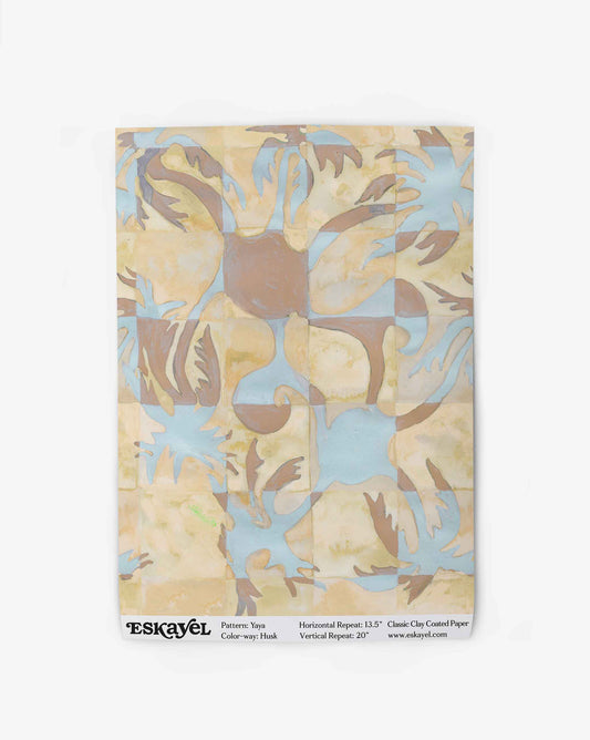 Yaya wallpaper in Husk as a swatch — beach-themed graphic botanical wallpaper in creamy yellow, earthy brown, and light blue | Eskayel