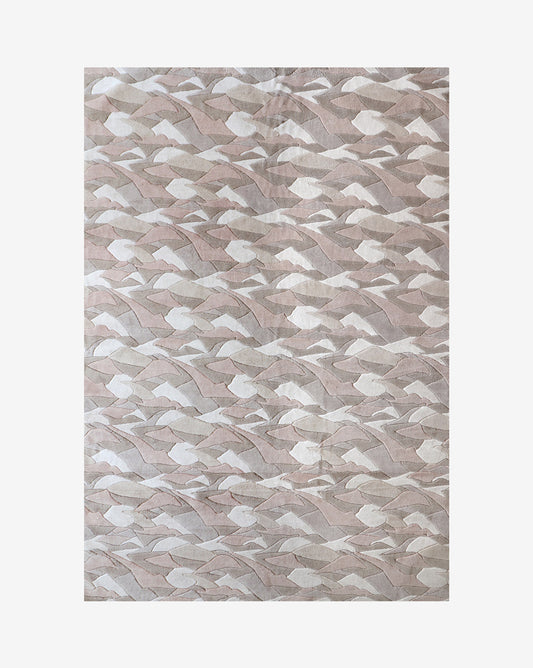 The Mani merino wool rug in Air features a neutral palette that includes white, beige, tan, and dusty pink