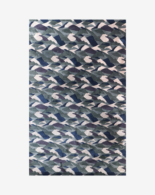 A blue and white camouflage pattern on a white background, resembling rippling Mani Hand Knotted Rug 5' x 8'