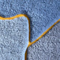In this swatch of the Sky and Sun colorway, Eskayel’s Pieces rug offers a palette with yellow, orange, and blue.