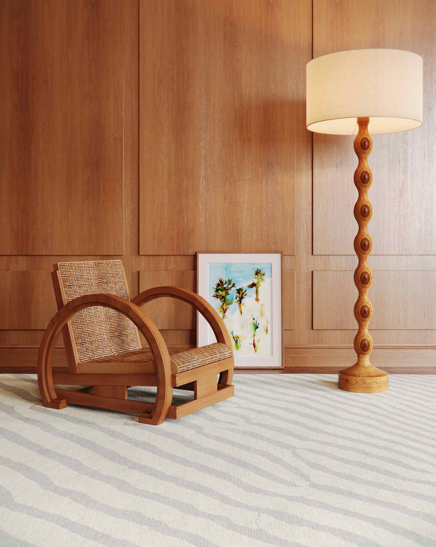 Eskayel’s Sand Lines rug in Sand offers a beige and grey colorway installed in a living room with a wood and rattan chair, photo frame, and a standing lamp. 