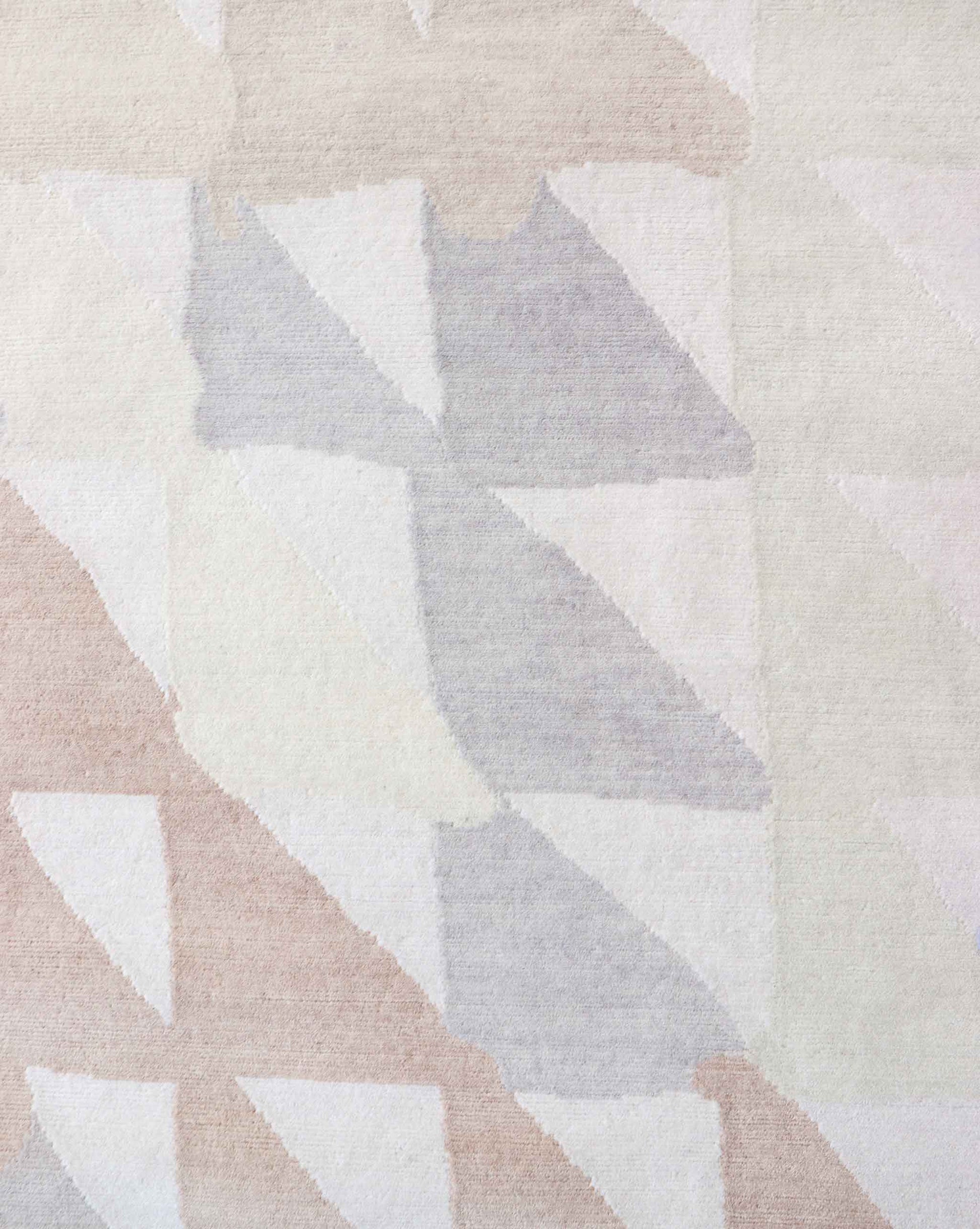 A close up of a Triangle Checks Hand Knotted Rug with triangles on it