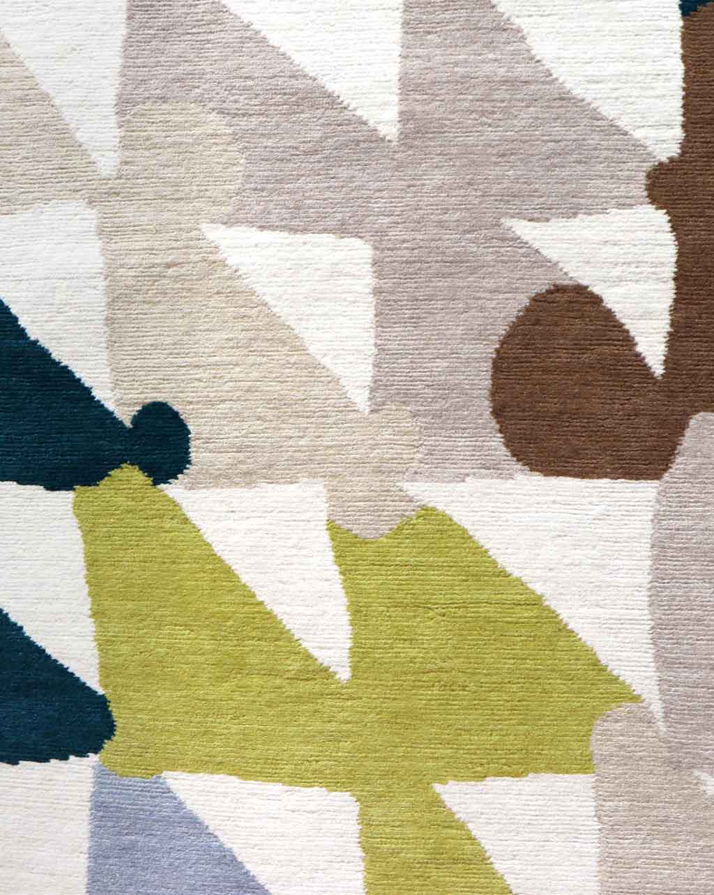 A close up of a Tibetan crossweave rug with geometric shapes such as checkerboards and Triangle Checks Hand Knotted Rug 5' x 8' Multi