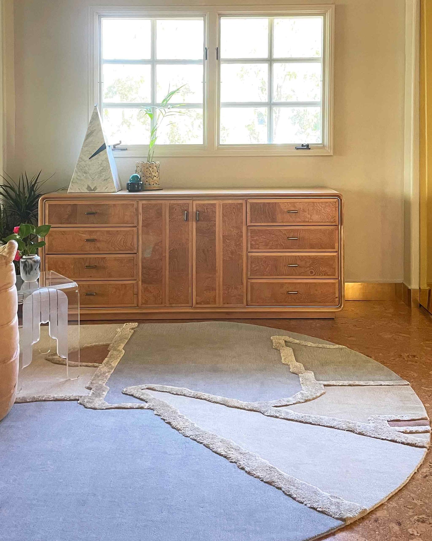 Cropped image of our studio-designed Pieces Mineral Hand knotted rug in a multicolored palette installed in a living room with a warm tone feel | Eskayel