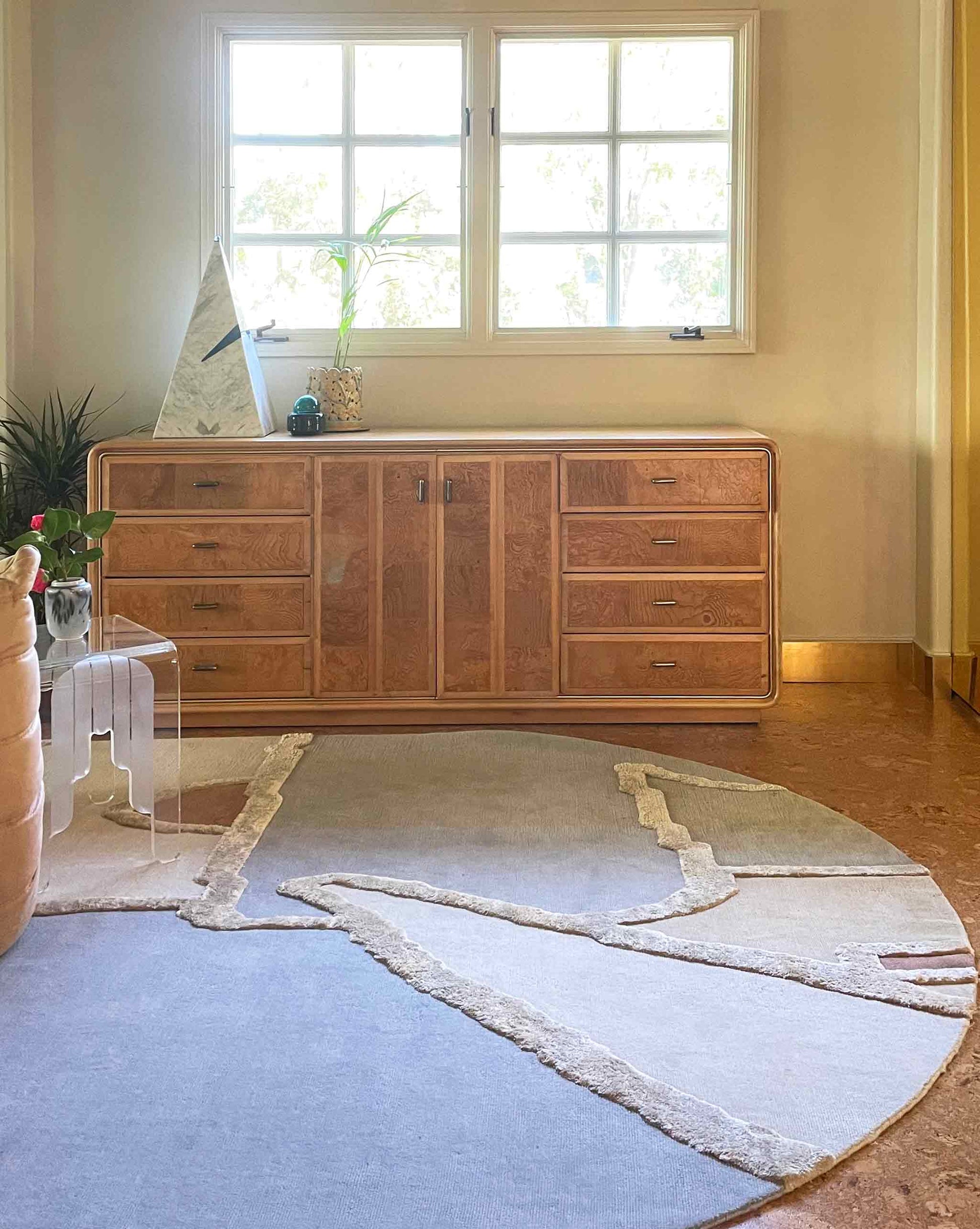 Cropped image of our studio-designed Pieces Mineral Hand knotted rug in a multicolored palette installed in a living room with a warm tone feel | Eskayel