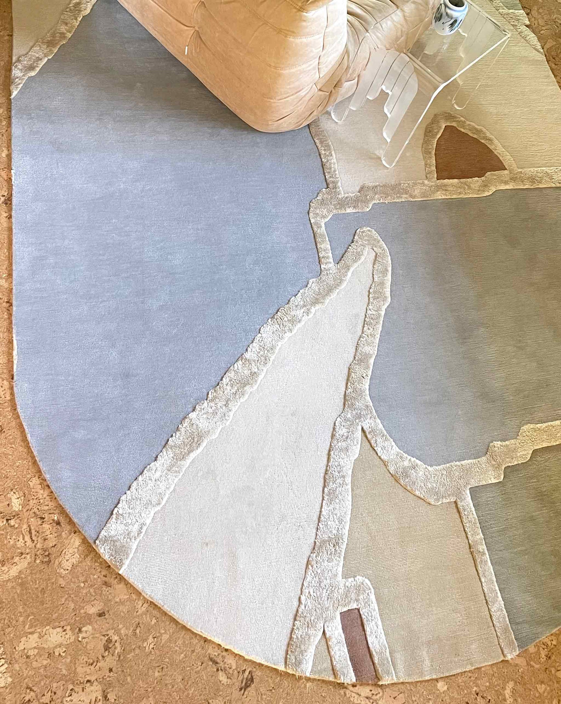 A cropped image of our hand-knotting studio-designed Pieces Mineral rug, a multicolored oval-shaped rug with a geometric pattern | Eskayel