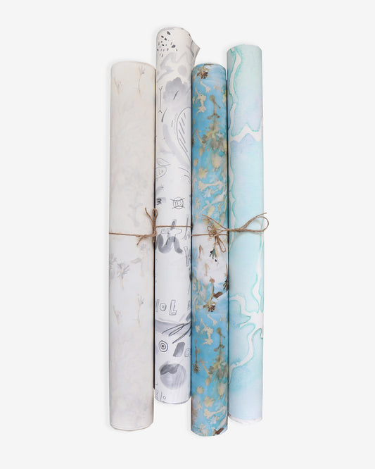A set of four rolls of Wrapping Paper Assorted with blue and white designs