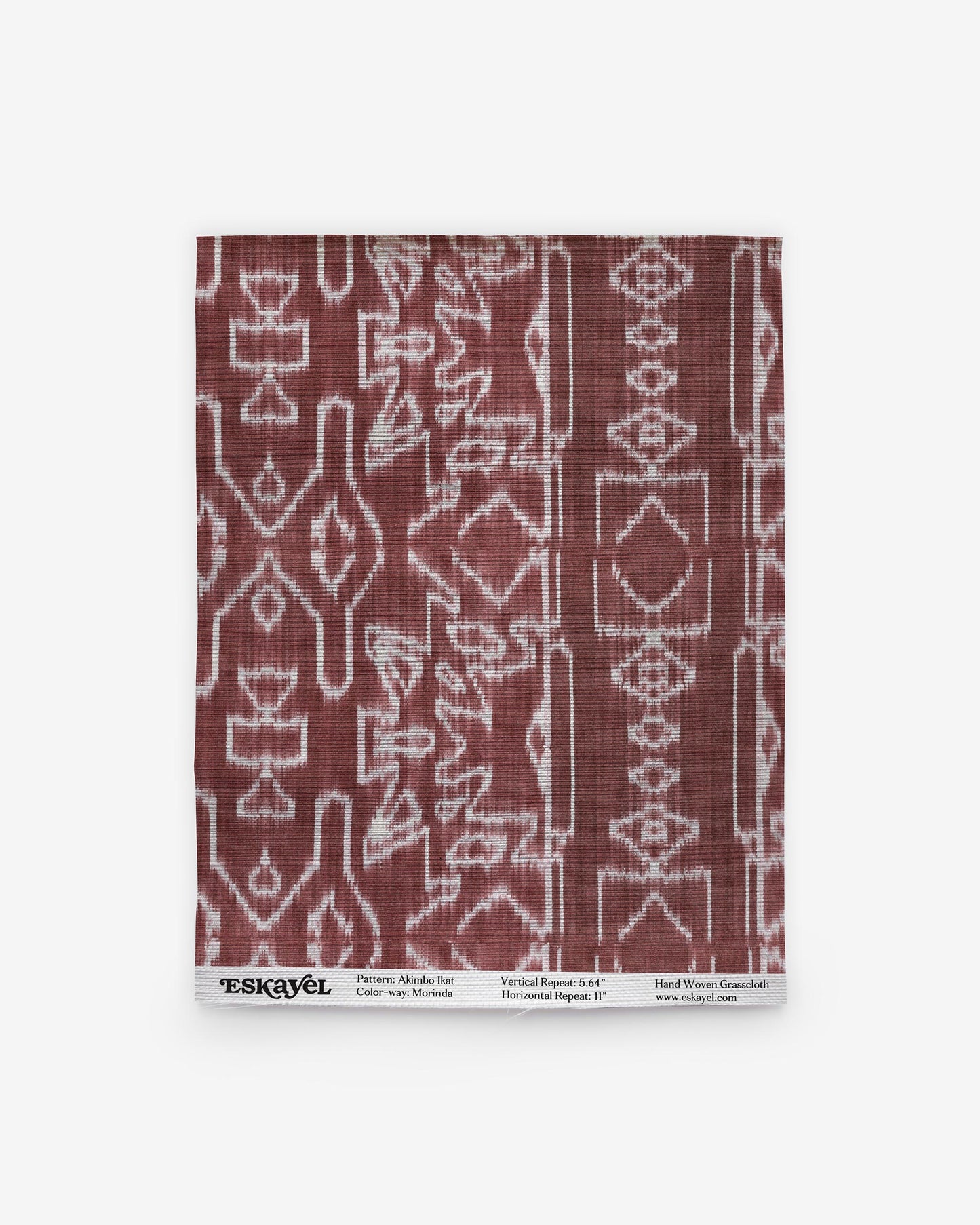 A burgundy and white Akimbo Grasscloth Morinda Ikat pattern on a napkin