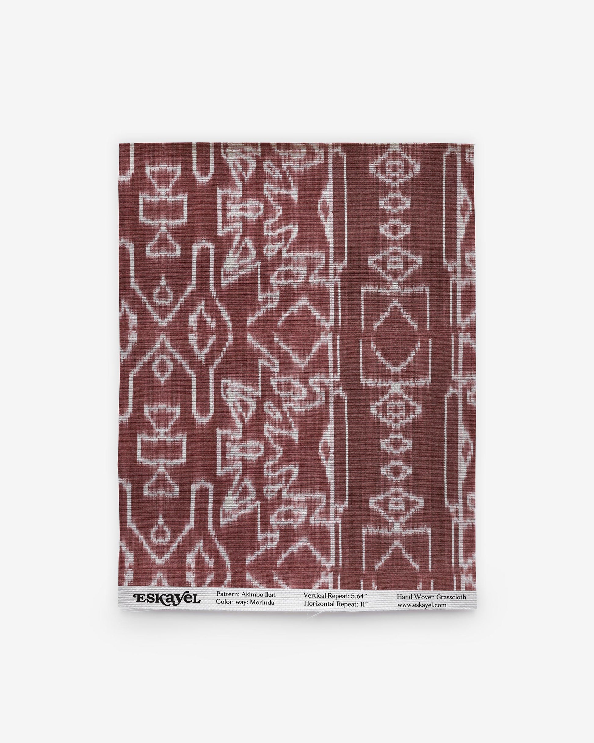A burgundy and white Akimbo Grasscloth Morinda Ikat pattern on a napkin