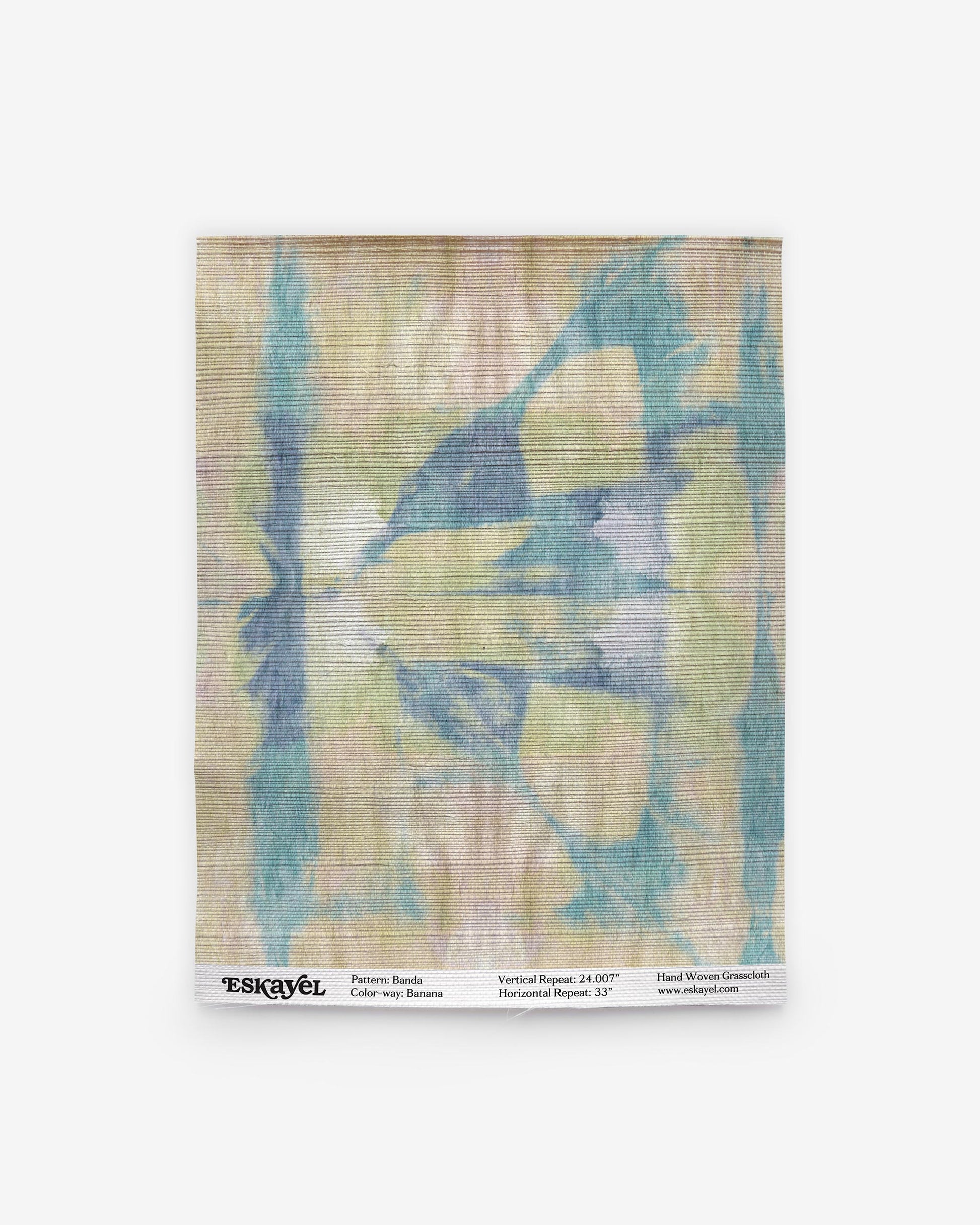 A blue and green tie dye pattern on wallpaper in the Banda Grasscloth Sample Banana is available for sample orderon wallpaper