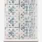 A blue and white Banda Grasscloth Chloros pattern on a roll of wallpaper