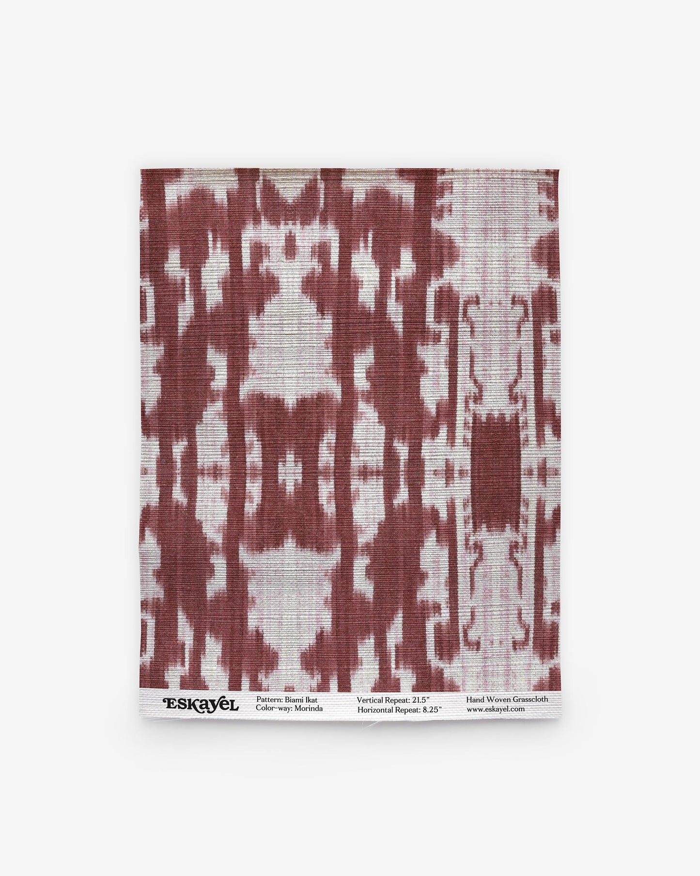 A luxurious Biami Grasscloth pattern with a red and white Morinda Ikat motif on wallpaper