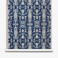 A blue and white Biami Grasscloth Indigo ikat on wallpaper