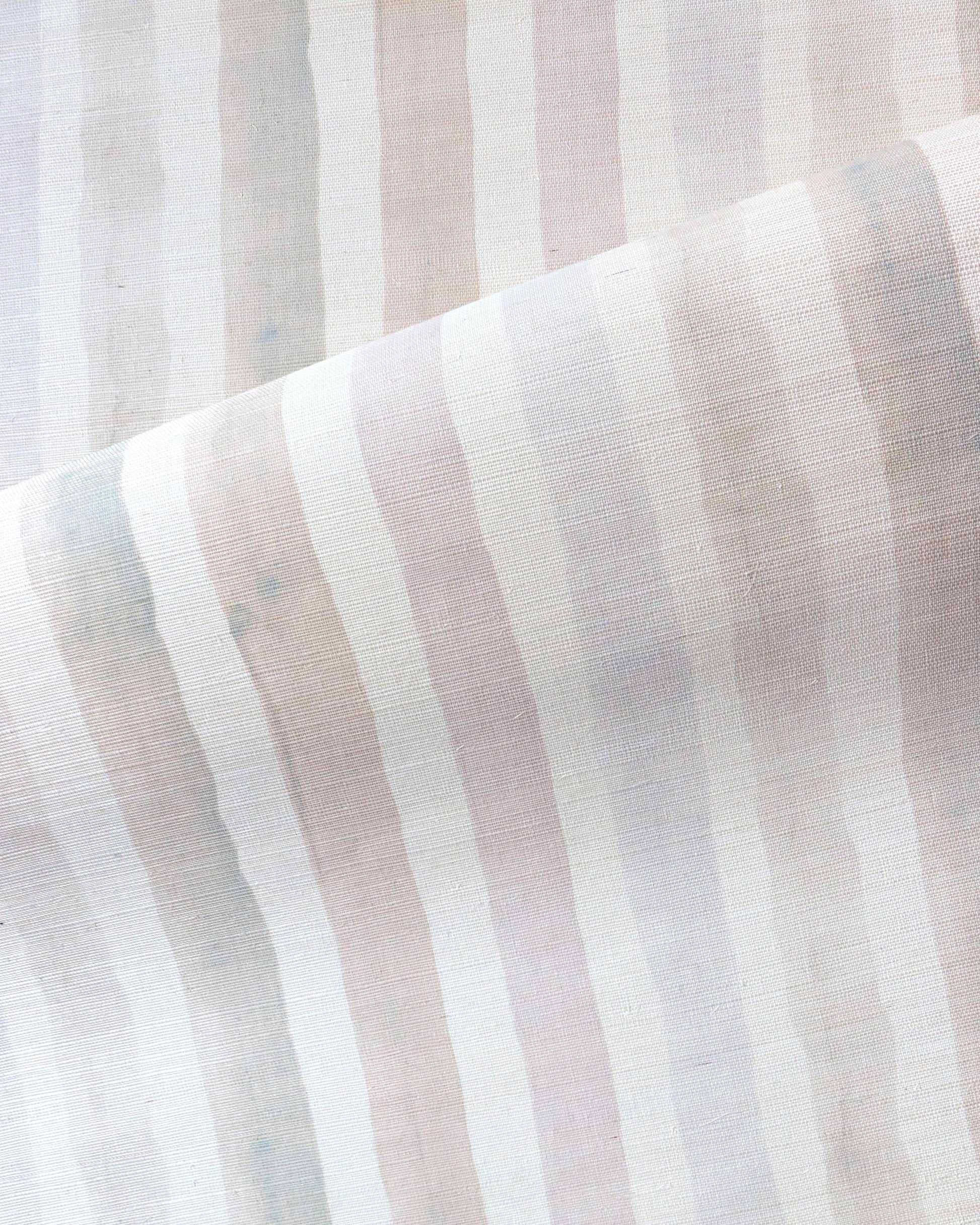 A close up image of a Gradient Stripe Grasscloth||Pink Island fabric in gradient stripe colorways.