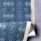 A blue and white fabric in an Omaha Kinship Grasscloth Indigo ikat colorway with Eskayel's Kinship pattern