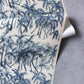 A blue and white Palm Dance Grasscloth Midnight with palm trees on it