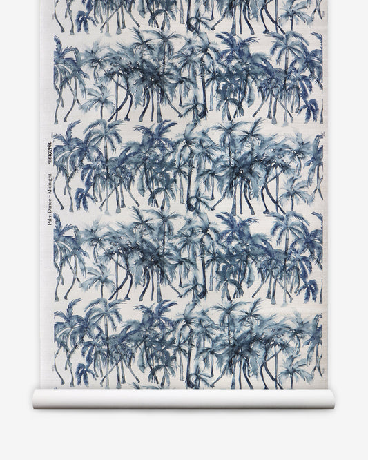 A blue and white print of Palm trees on a roll of Palm Dance Grasscloth Midnight wallpaper