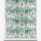 A roll of Palm Dance Grasscloth wallpaper with a Palm Dance pattern featuring palm trees on it