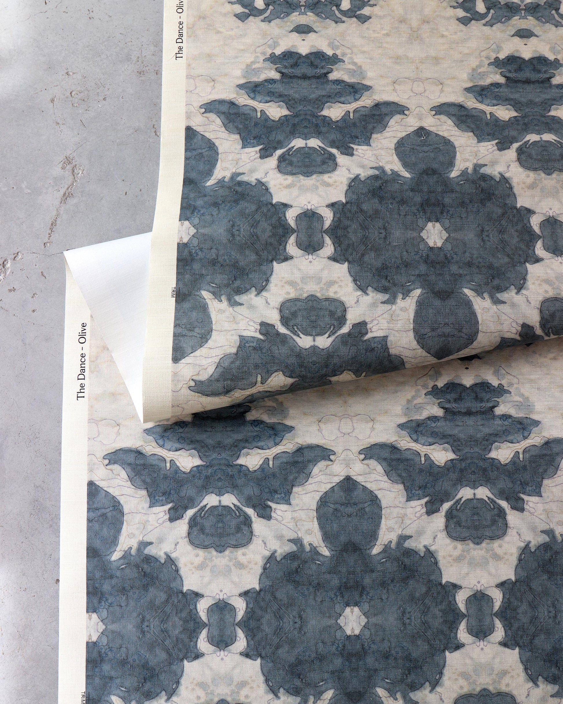 A floral pattern on a blue and white paper from the Lora Collection in The Dance Grasscloth Olive colorway