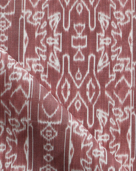 A close up of a red and white Akimbo Fabric with a graphic geometric pattern.