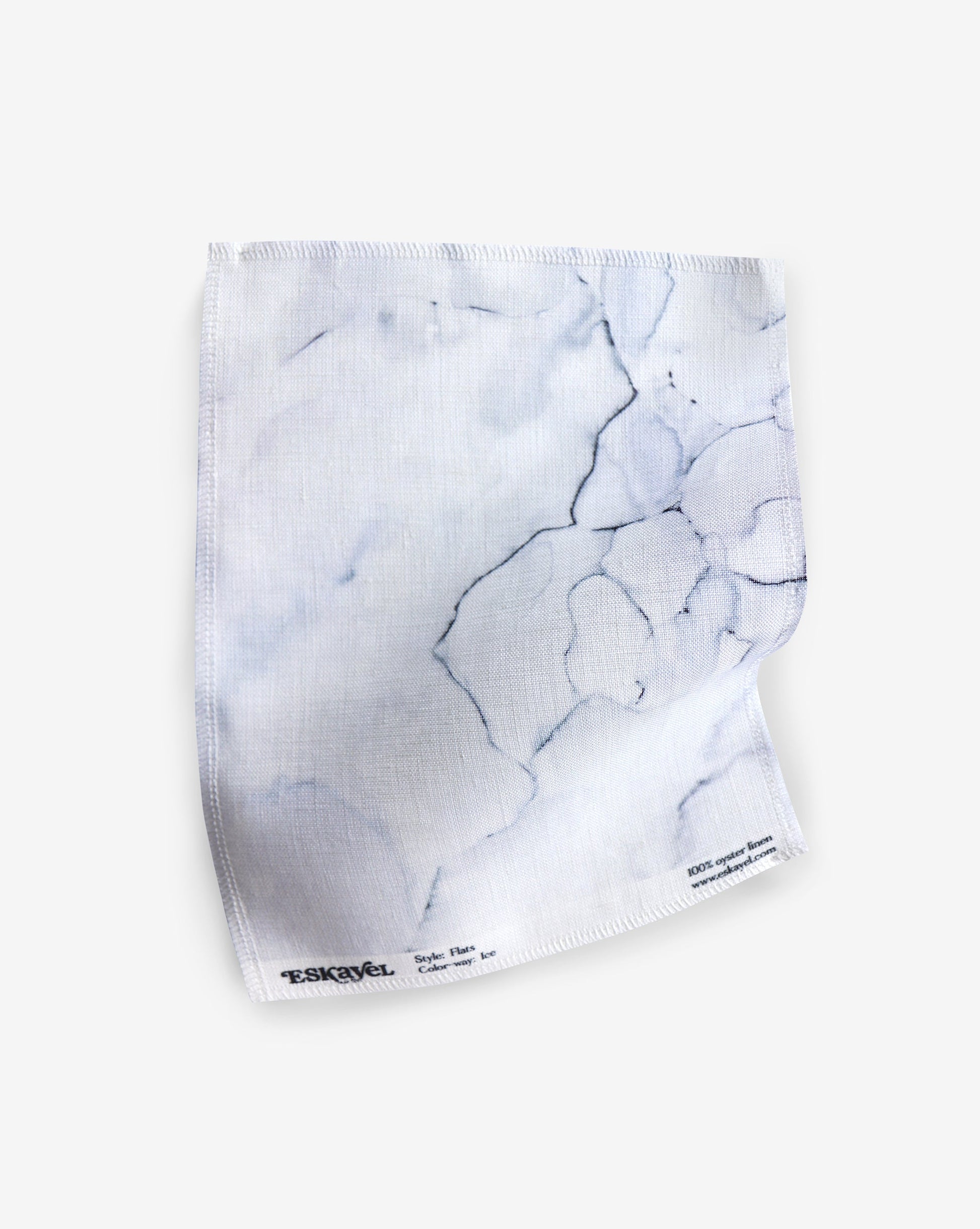 A white fabric made of Aquarelle Fabric with a marble pattern on it