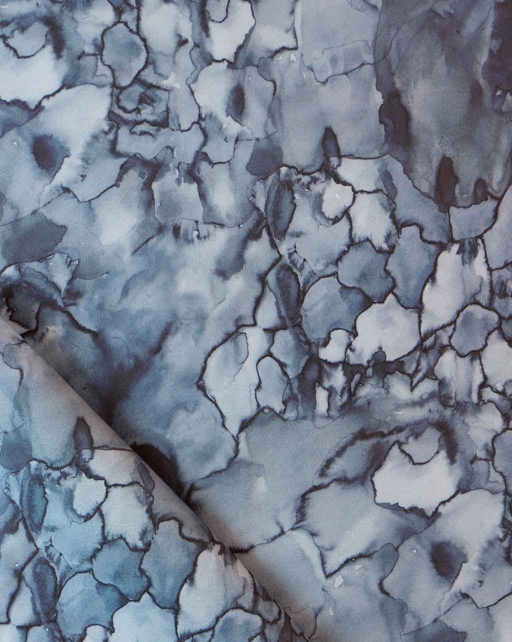 A close up of a blue and white Aquarelle Fabric in the Ocean colorway
