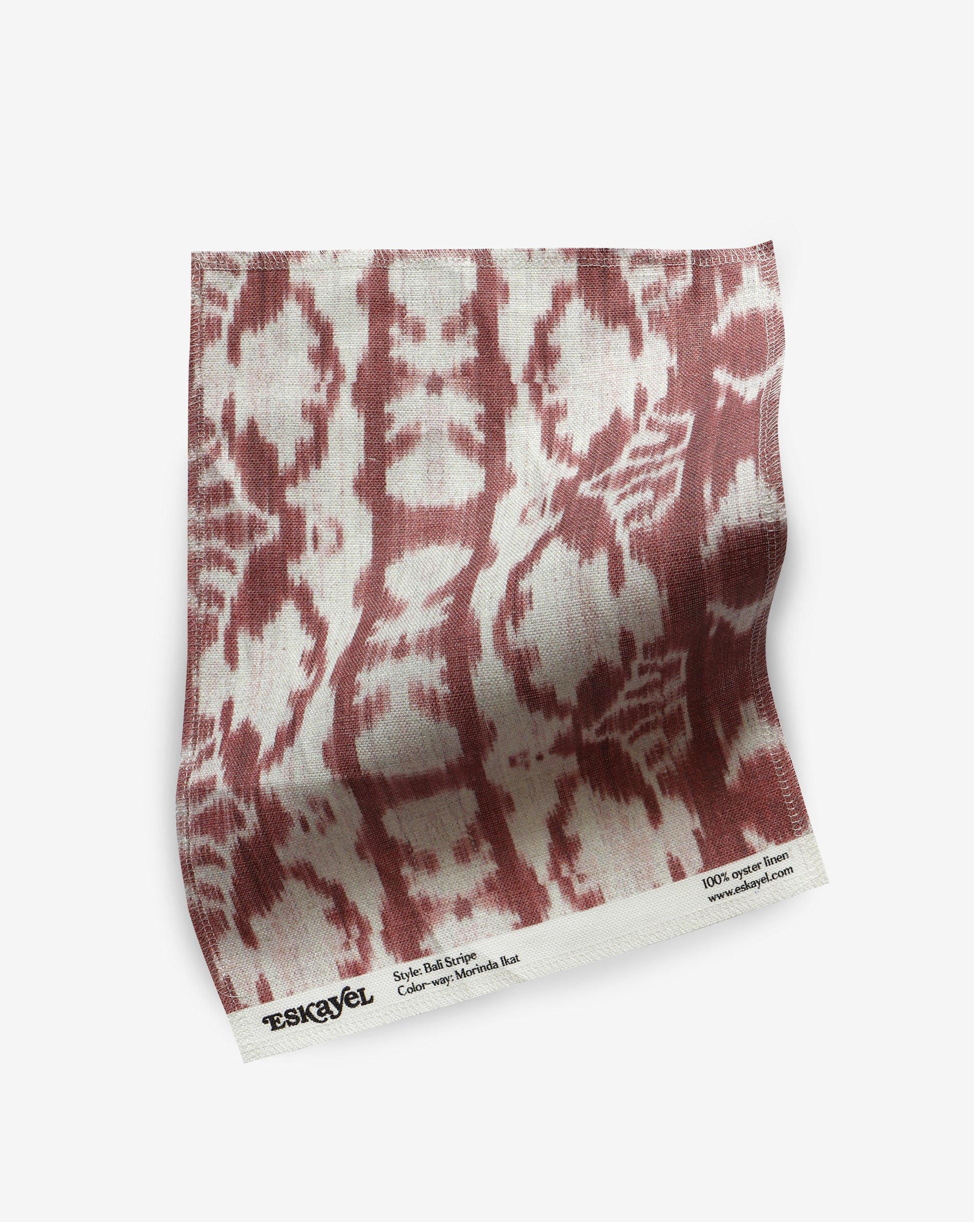 A red and white Bali Stripe Fabric or Morinda Ikat print on a white background, ideal for luxury fabric