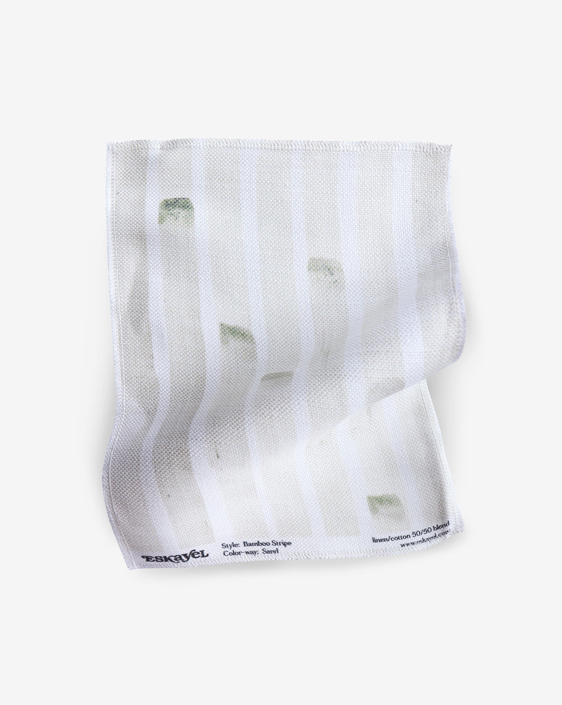 A white Bamboo Stripe Fabric hankerchief with green stripes on it.