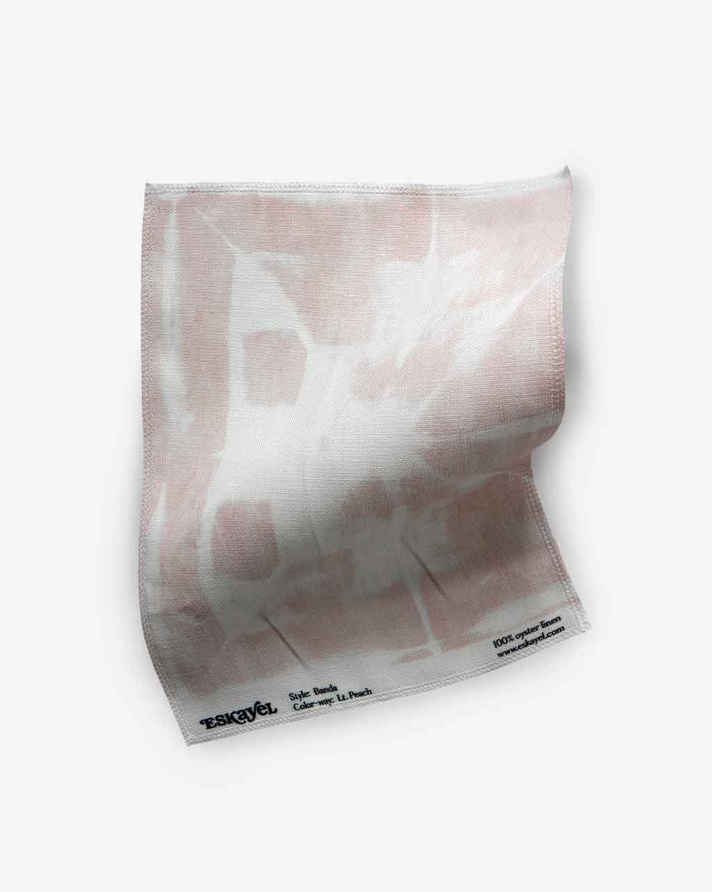 A Banda Fabric Light Peach tie-dye technique on a white surface