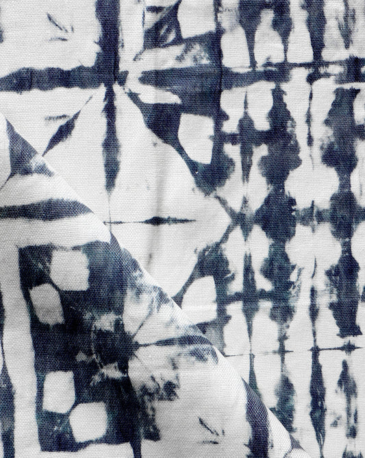 A close up of a blue and white tie dyed Banda Fabric||Midnight, using Banda and shibori tie-dye techniques.
