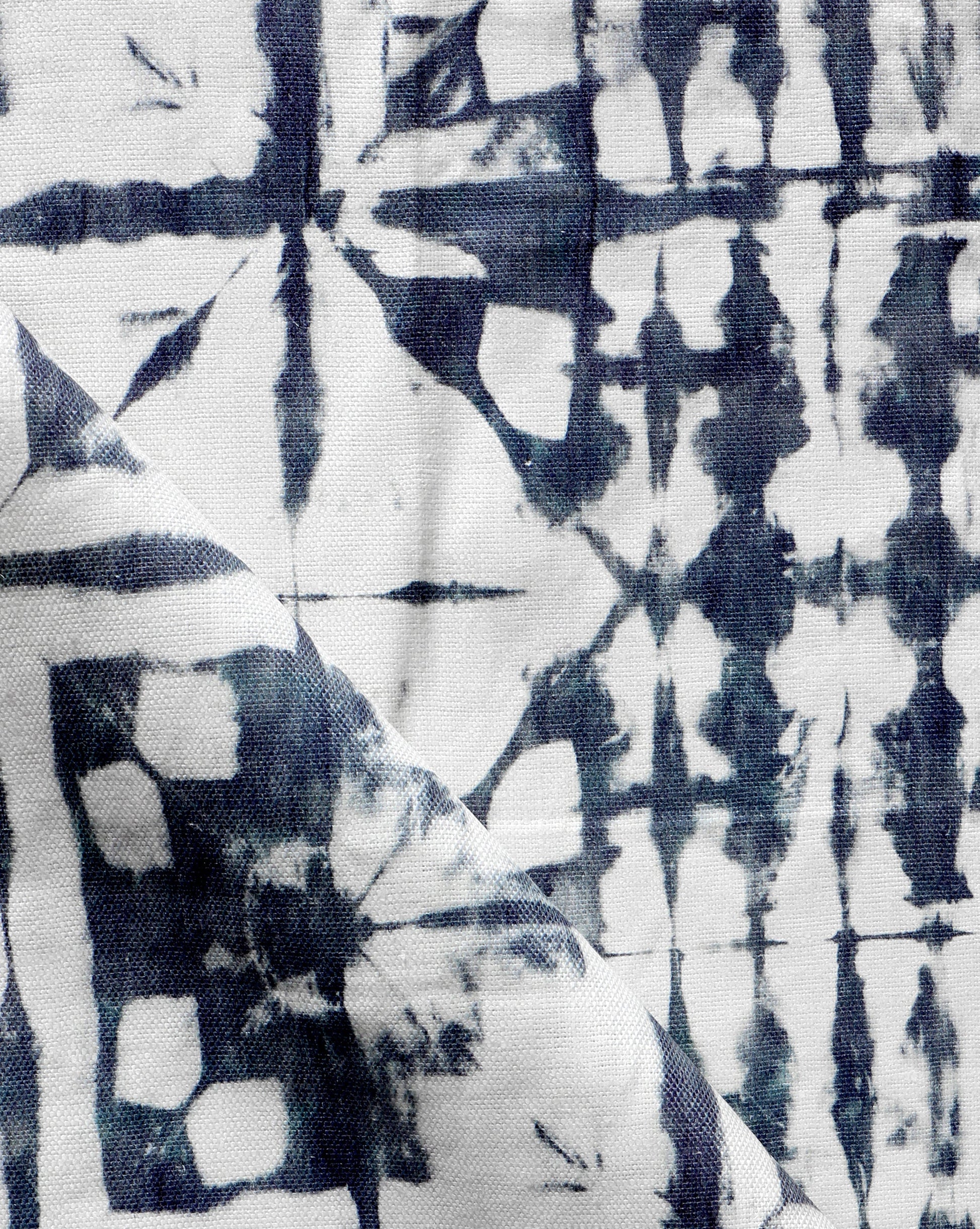 A close up of a blue and white tie dyed Banda Fabric Midnight, using Banda and shibori tie-dye techniques