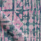 A high-end Banda Fabric with a pink and blue tie dyed pattern created using shibori tie-dye techniques
